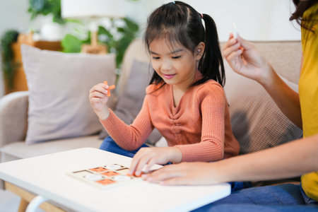 Happy family playing board game at home, happiness conceptの写真素材