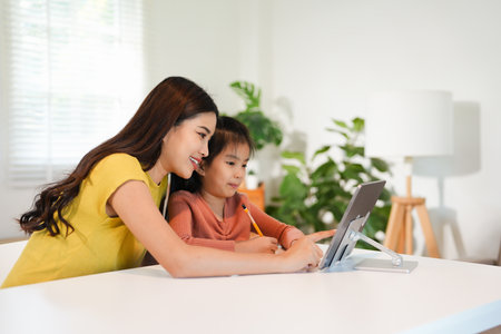 Asian parent teaching homework to children and participate e-learning online education class group...
