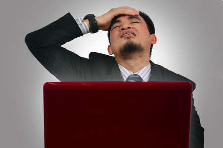 asian young businessman disappointed because loss of profitの写真素材