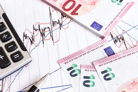 Euro banknotes with calculator and pen