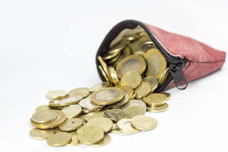 Coin purse filled with coins isolatedの写真素材