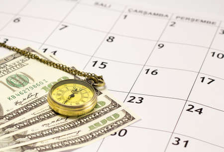Pocket watch with money on the calendar. Time is money.