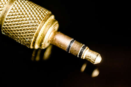 Golden jack plug isolated on black