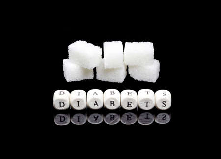 Diabetes word written on wooden cubes with white sugarの写真素材