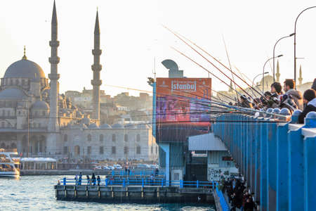 Fisherman fishing at sunset on the Galata Bridge in Istanbul Turkeyのeditorial素材