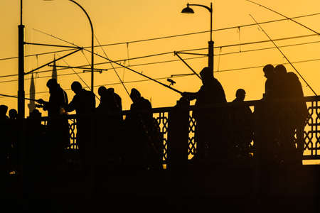 Fisherman fishing at sunset on the Galata Bridge in Istanbul Turkeyのeditorial素材