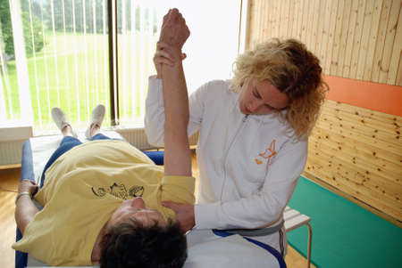 SAALFELDEN, AUSTRIA - AUGUST 30: physical therapist exercising with senior rheumatism patient on August 30, 2007 at rehabilitation center in Saalfelden, Austria.のeditorial素材