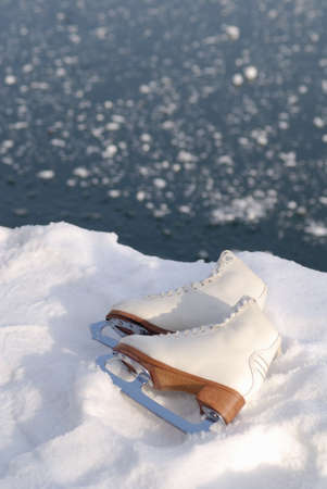 Close up of ice skating shoe at frozen lake in austria.の写真素材