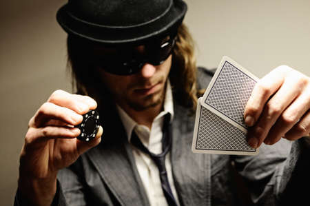 Man with hat and glasses playing underground poker.のeditorial素材