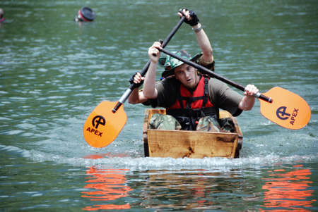 MITTERSILL, AUSTRIA - JUL 4: Participants at Water Fun Event called Erdinger Sautrogrennen on July 4, 2010 at the Zierteich in Mittersill, Austriaのeditorial素材