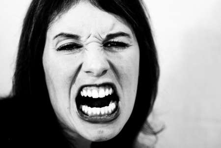 Black and white shot of mad, screaming woman.の写真素材