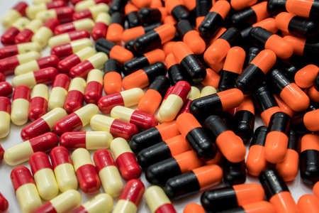 Orange, black, red, pale yellow, capsule pillsの写真素材