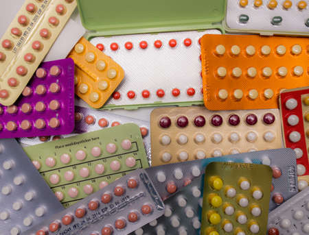 Piles of colorful birth control pills with modern packagingの写真素材