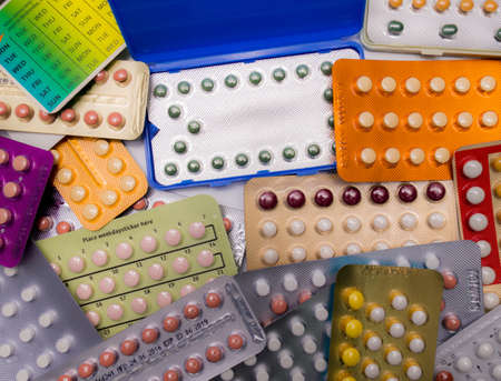 Piles of colorful birth control pills with modern packagingの写真素材