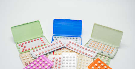 Piles of colorful birth control pills with modern packagingの写真素材