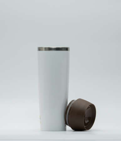 Modern thermos bottle with opened lid isolated on white backgroundの写真素材