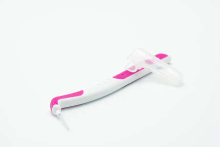 Interdental brush and cover isolated on white backgroundの写真素材