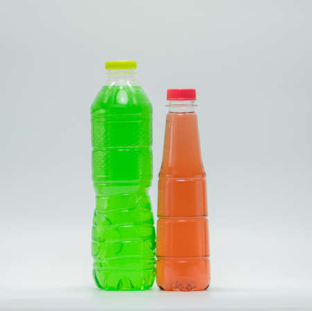 Two bottles of soft drink in modern plastic packaging on white backgroundの写真素材