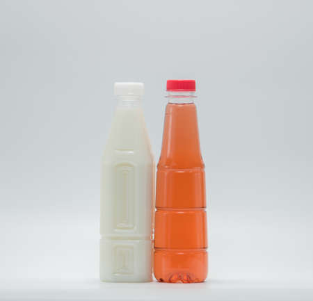 Soy milk and soft drink in modern plastic packaging on white backgroundの写真素材