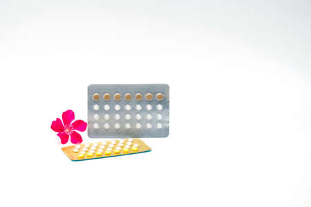 Contraceptive pills with pink flower on white backgroundの写真素材