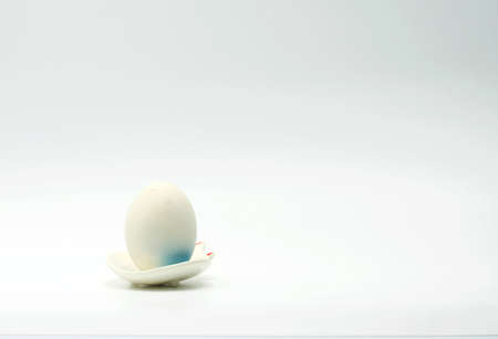 Boiled eggs with blue bottom laid on a tile dishの写真素材