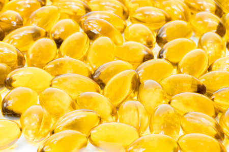 Fish oil in soft gelatin capsule isolated on white backgroundの写真素材