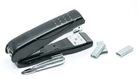 Black stapler and staples on white background, office accessories