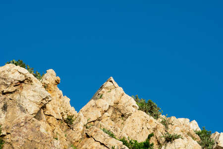 Rock cliff and clear blue skyの写真素材