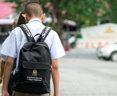 CHONBURI, THAILAND-AUGUST 3, 2017 : Thai school boy with backpack walks to school in the morning