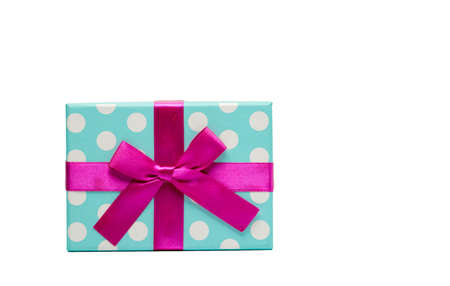 Polka dotted gift box with pink ribbon bow isolated on white background with copy space, just add...