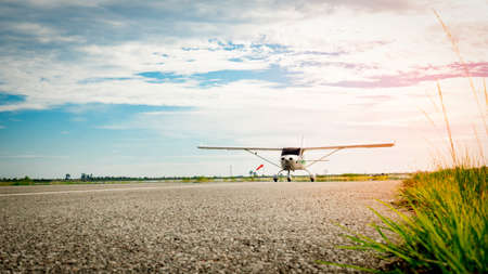 Small airplane coming  on a taxiway in the morning with beautiful blue sky. Bright life. High growth and high risk business concept.の写真素材