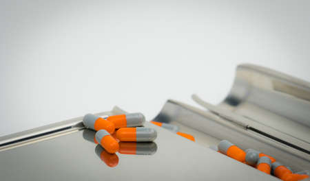 Colorful of antibiotic capsules pills with shadows on stainless steel drug tray, drug resistance concept.の写真素材