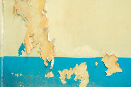 Old white and blue peeling paint cement walls.の写真素材