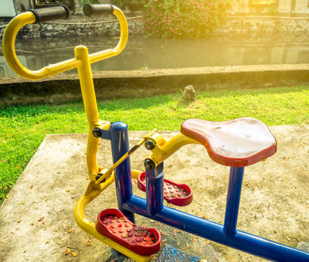 The exercise bike was installed on the cement floor next to the canal. Artificial sunlight . After rain. Healthy lifestyle.の写真素材