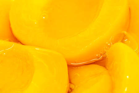 Closeup canned peach halves in syrupの写真素材