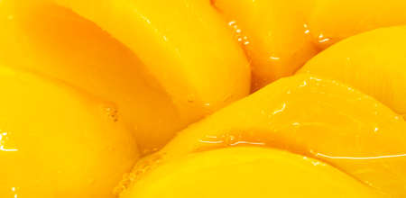 Closeup canned peach halves in syrupの写真素材