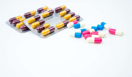 Colorful of antibiotic capsules pills on white background with copy space. Drug resistance, antibiotic drug use with reasonable, health policy and health insurance concept.の写真素材