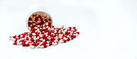 Colorful of antibiotic capsules pills with plastic bottle on white background. Drug resistance, antibiotic drug use with reasonable, health policy and health insurance concept.の写真素材