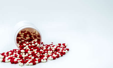 Colorful of antibiotic capsules pills with plastic bottle on white background. Drug resistance, antibiotic drug use with reasonable, health policy and health insurance concept.の写真素材