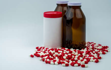 Colorful of antibiotic capsules pills with three bottles on white background. Drug resistance, antibiotic drug use with reasonable, health policy and health insurance concept.の写真素材