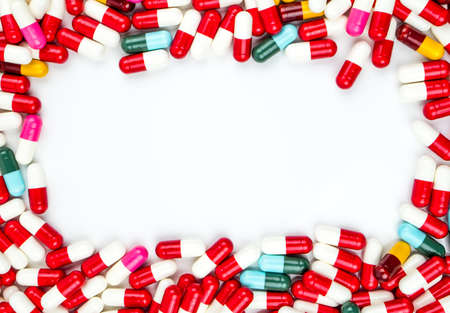Colorful of antibiotics capsule pills rectangle frame on white background with copy space. Drug...