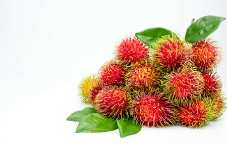 Fresh red ripe rambutan (Nephelium lappaceum) with leaves isolated on white background. Thai dessert sweet fruits.の写真素材
