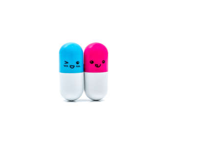 Cute blue and pink couple capsule pills isolated on white background with copy space for text.