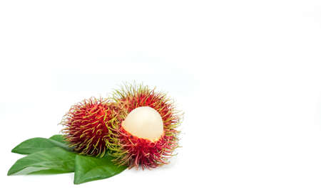 Closeup of fresh red ripe rambutan (Nephelium lappaceum) with leaves isolated on white background. Thai dessert sweet fruits. Tropical fruit.の写真素材
