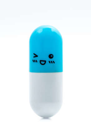 Blue and white capsule pill isolated on white background with copy space for text. Global healthcare concept. Healthy and happy life.の写真素材