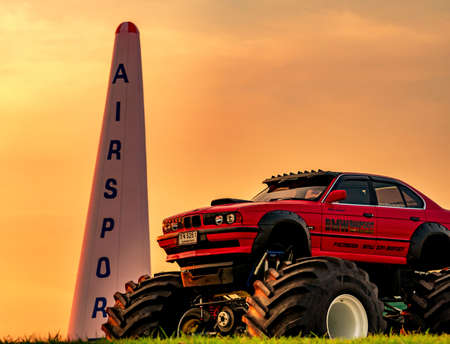 RAYONG, THAILAND-NOVEMBER 18, 2017 : Red BMW car 4x4 bigfoot parked on green grass in Air Race 1 World Cup Thailand 2017 at U-Tapao Naval Air Baseのeditorial素材