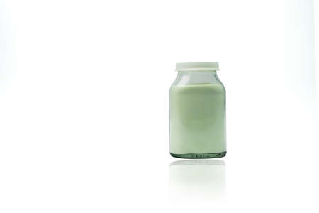 Green lemon flavored effervescent powders in transparent glass bottle with blank label and copy space isolated on white backgroundの写真素材
