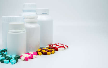 Antibiotic capsules pills and plastic bottle with blank label isolated on white background with copy space. Drug resistance concept. Antibiotics drug use with reasonable and global healthcare concept.の写真素材