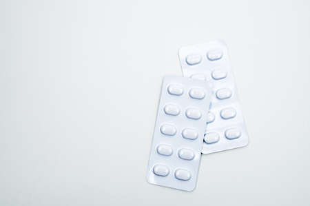 Tablets pill in white blister pack for light resistance packaging isolated on white background. Medicine for treatment NCDs. Elderly people disease.の写真素材