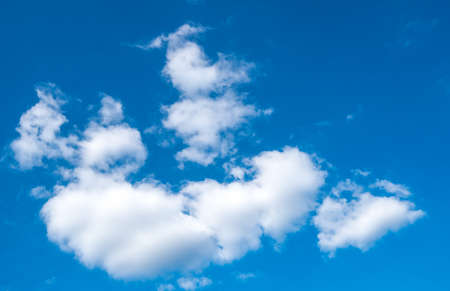 Beautiful white cumulus clouds and blue sky with spaceの写真素材